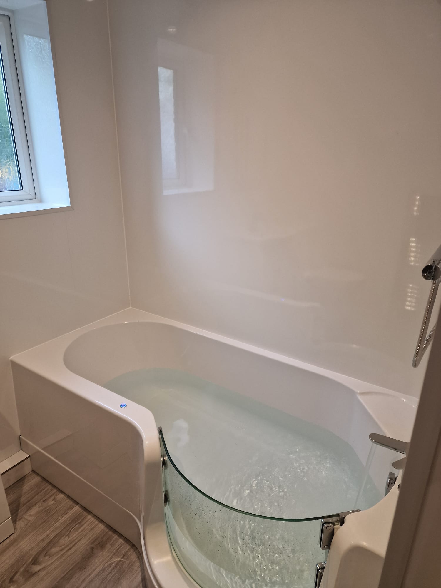 Newly fitted navy shaker kitchen with stone worktop, gas hob and stainless extractor in a Yorkshire home