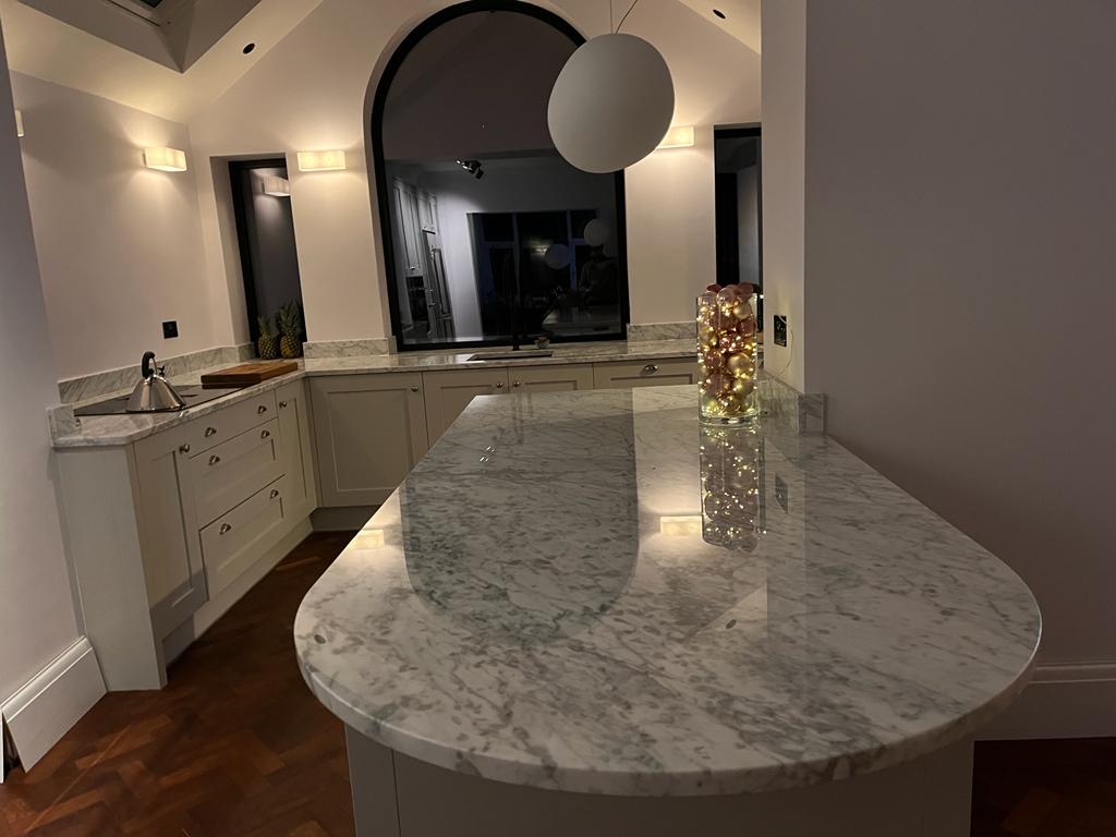 Premium kitchen renovation with cream shaker units, full marble island worktop and pendant lighting